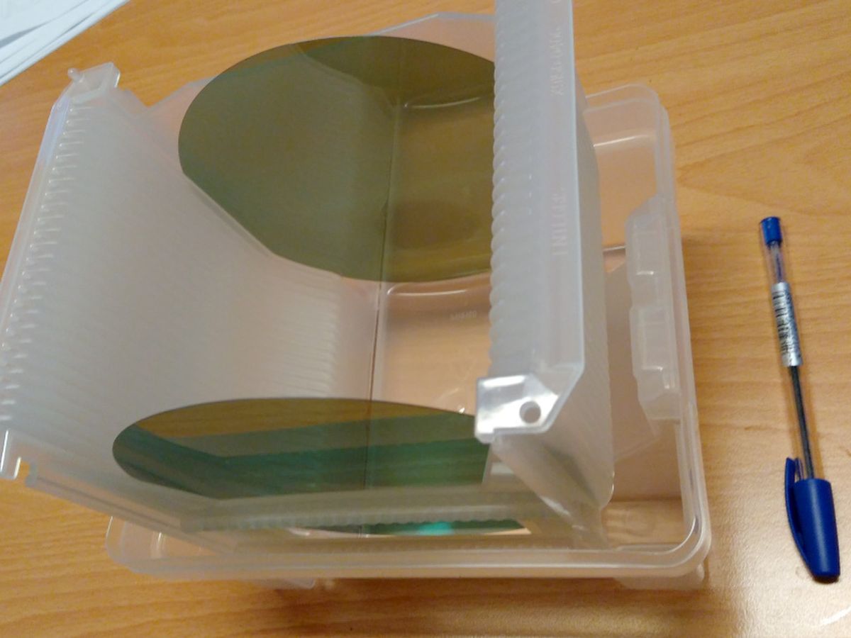 Six-inch wafers standing in an open plastic wafer cassette